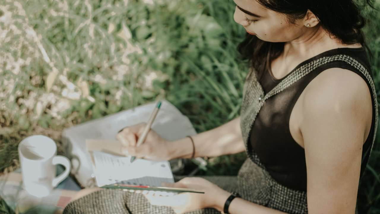Woman Journaling in Outdoors 